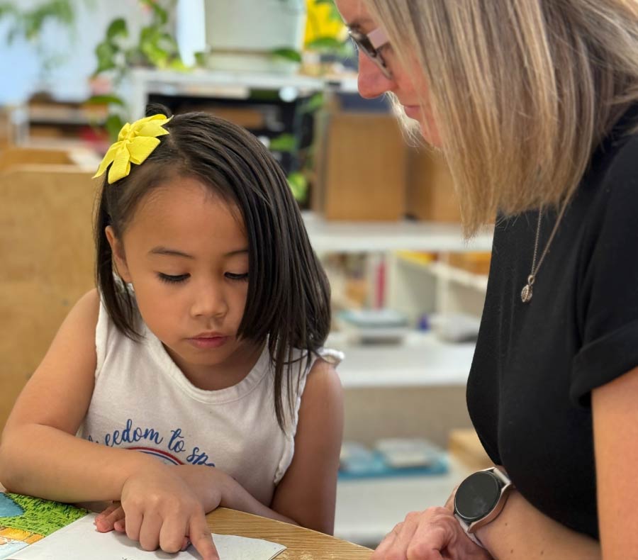 A well-organized, spacious Montessori school in visalia classroom featuring open shelves, educational materials, learning stations, and ample natural light, designed to foster student independence.