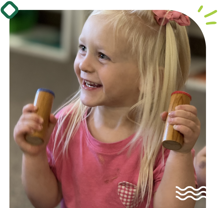 A young child focuses on a sensorial activity